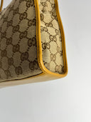 Profil du sac Gucci vintage : motif GG et bordure moutarde